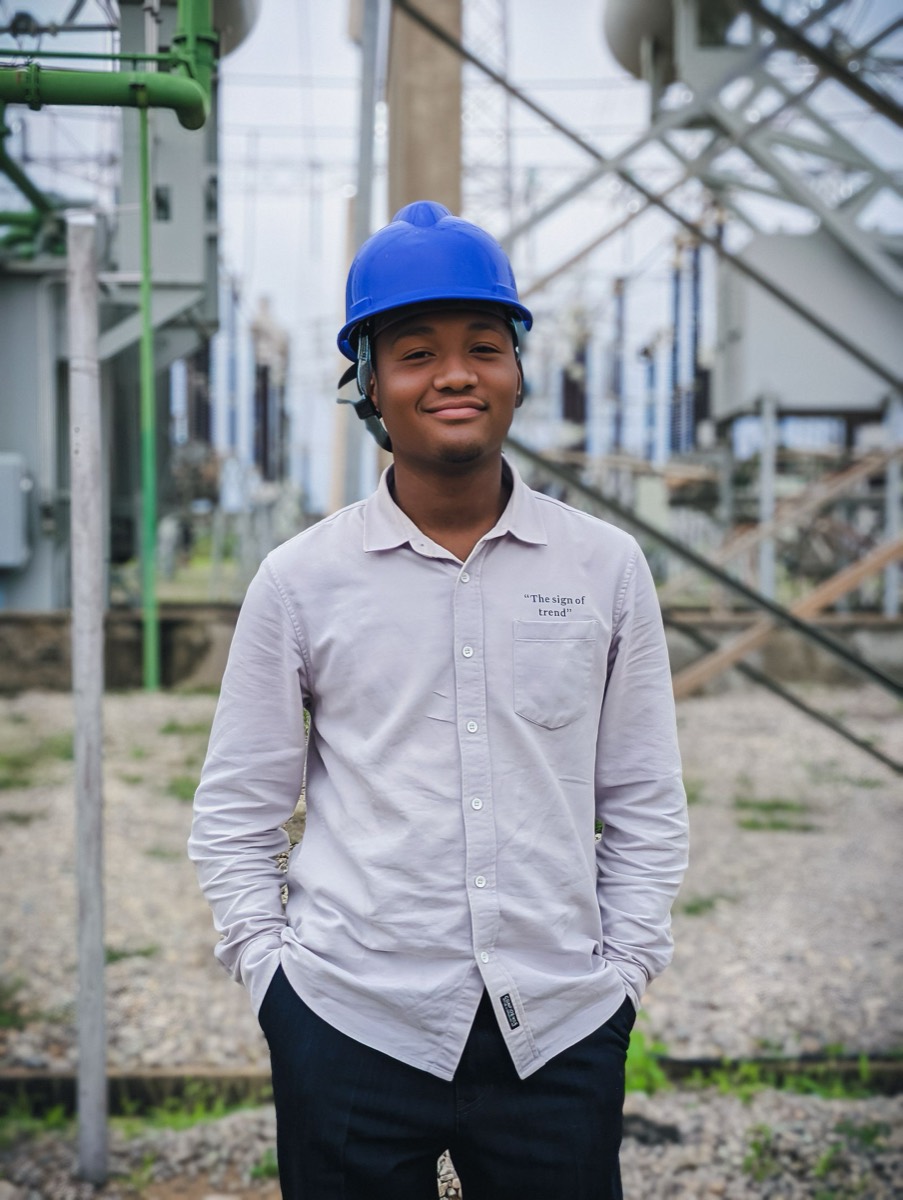 Engineer in a hard hat at a power installation