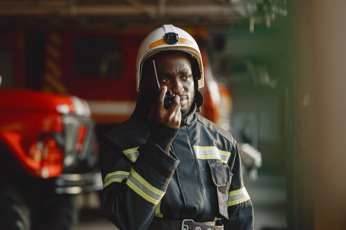 Firefighter coordinating a response over a two-way radio